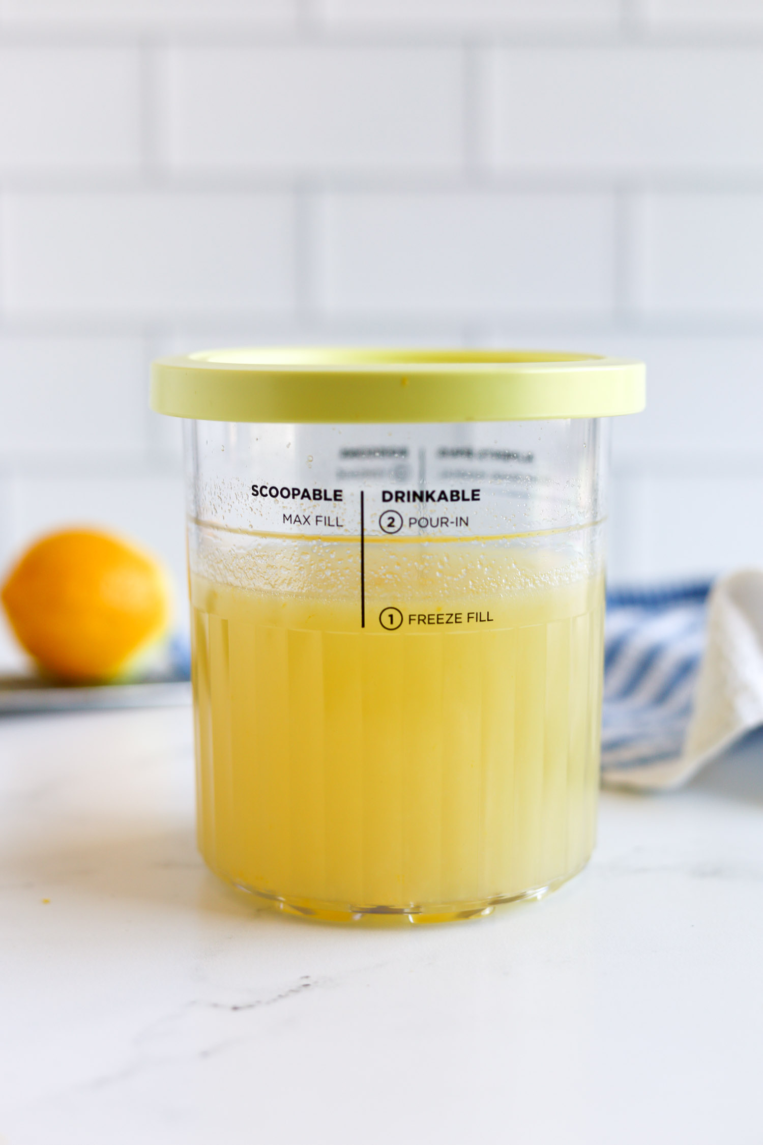 adding lemon sorbet base to creami pint container 