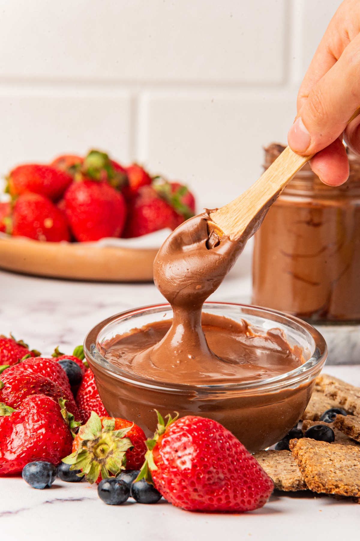 getting a spoonful of chocolate hazelnut spread with fruit