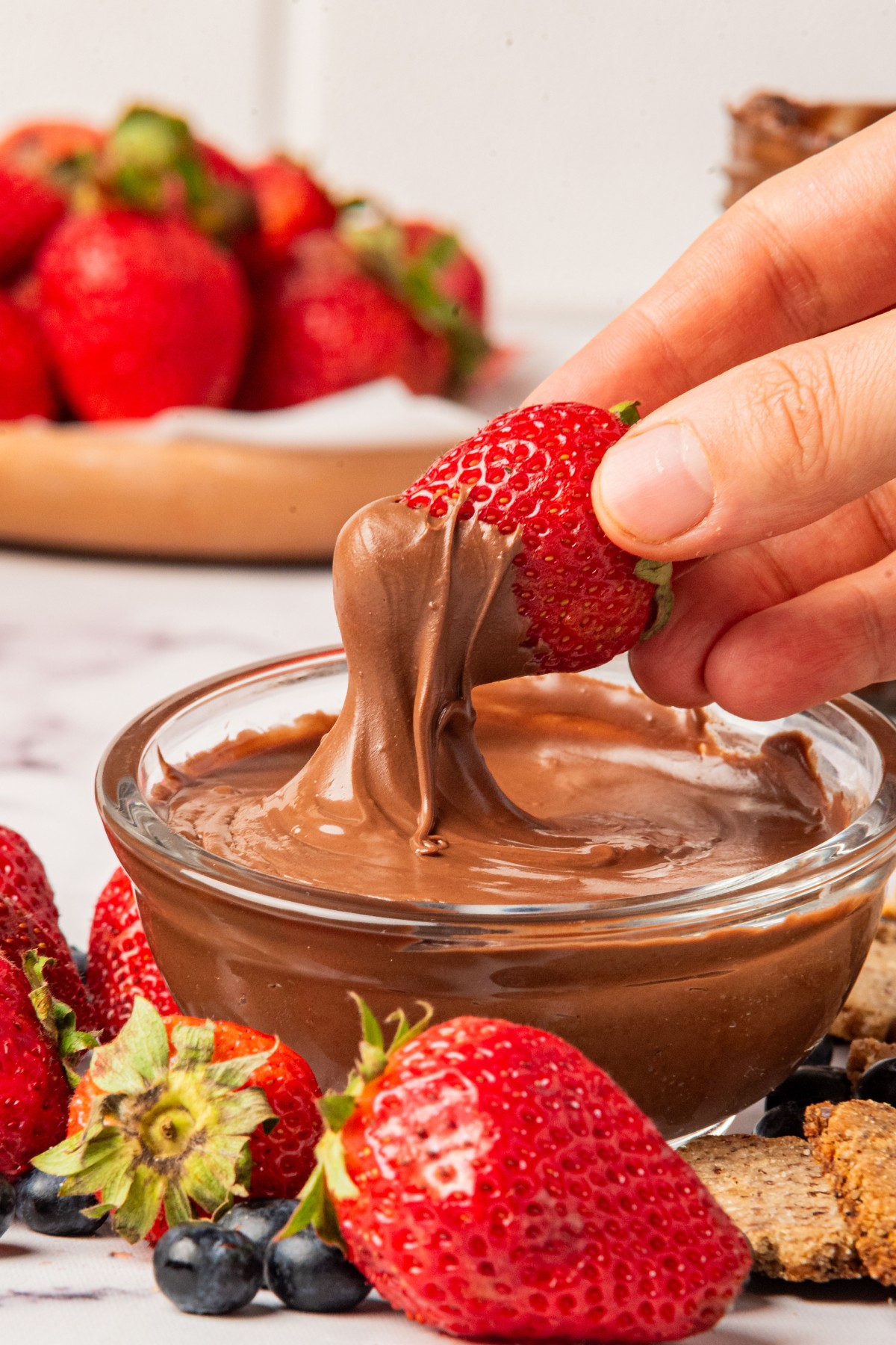 dipping strawberries in nutella 