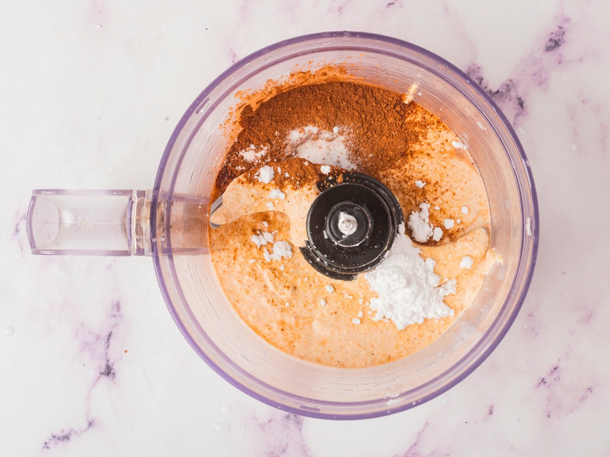 adding salt and cocoa powder to crushed hazelnuts