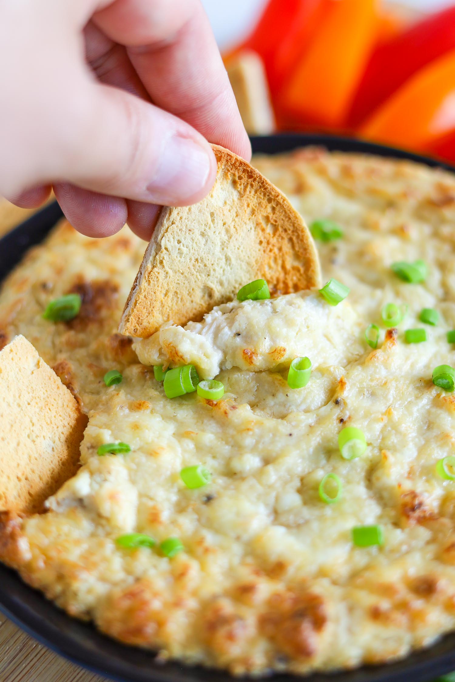 dipping keto bread into crab dip with cream cheese