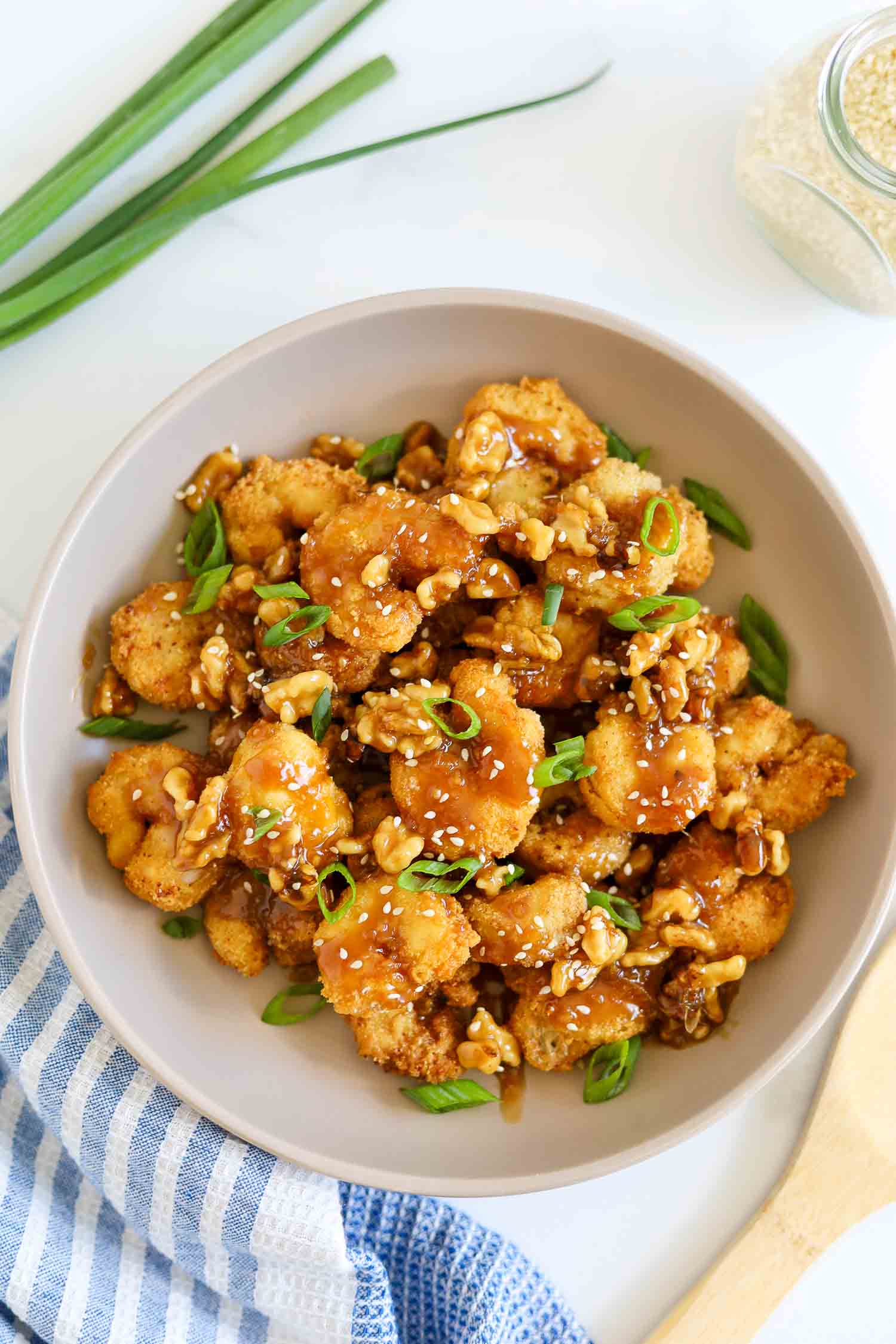 Chinese honey walnut shrimp in a white bowl 