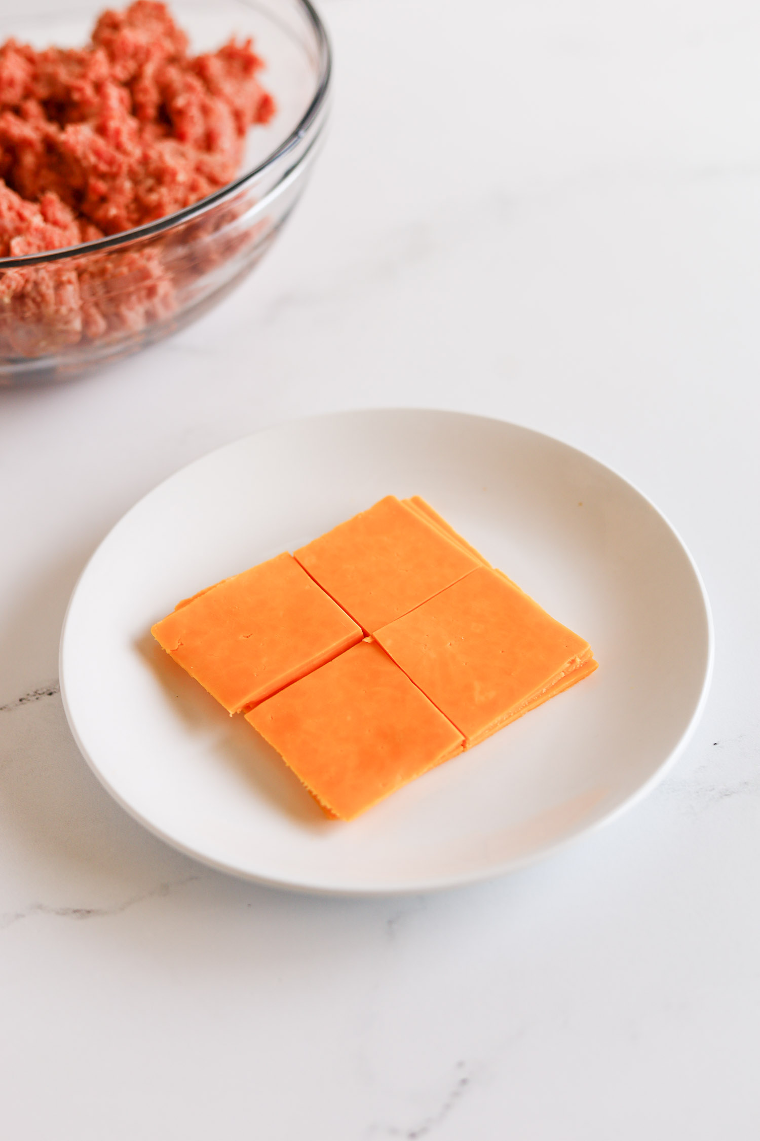 sliced cheddar cheese on a white plate 