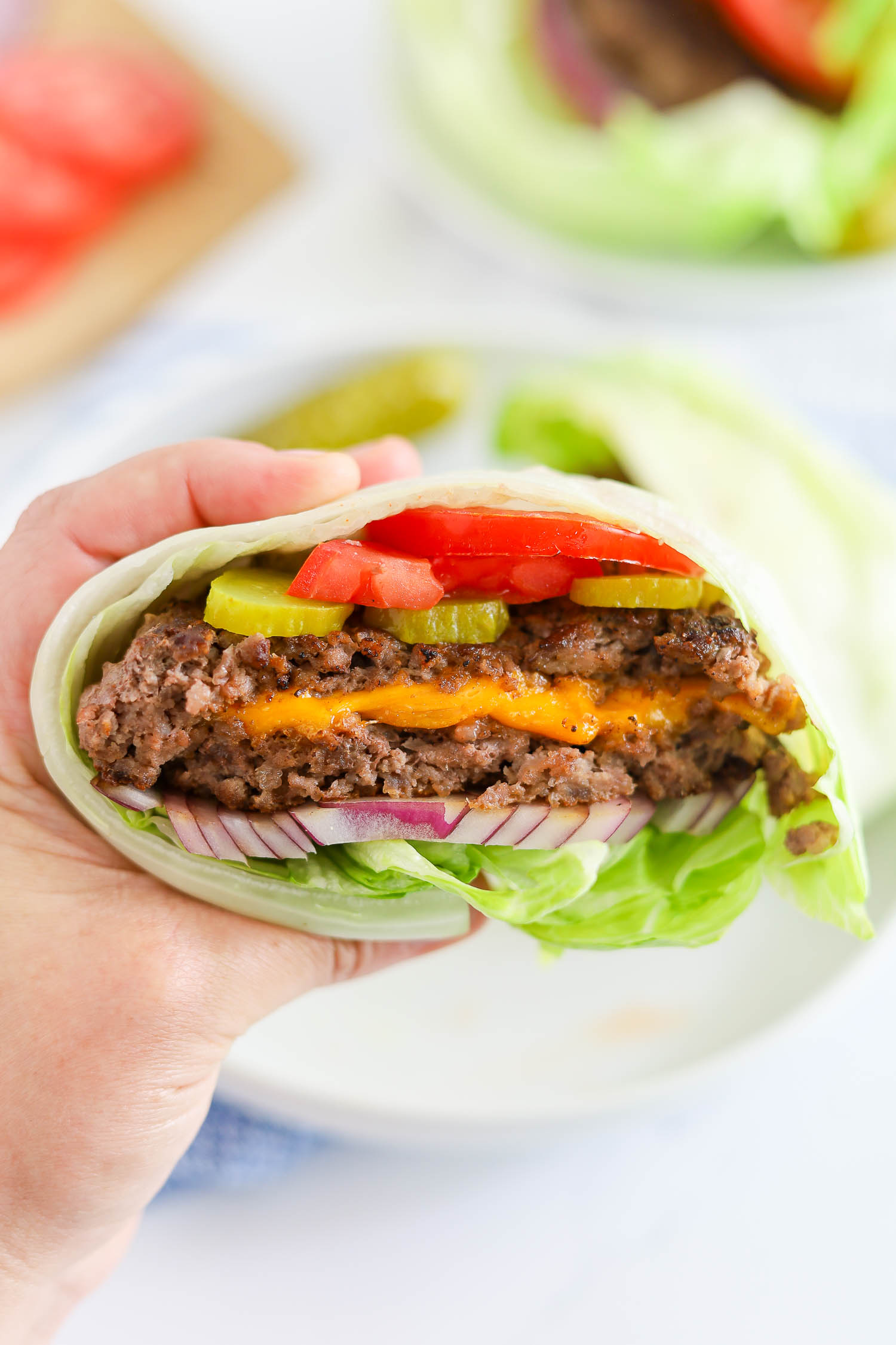 dressed cheese stuffed burger with fixings. 