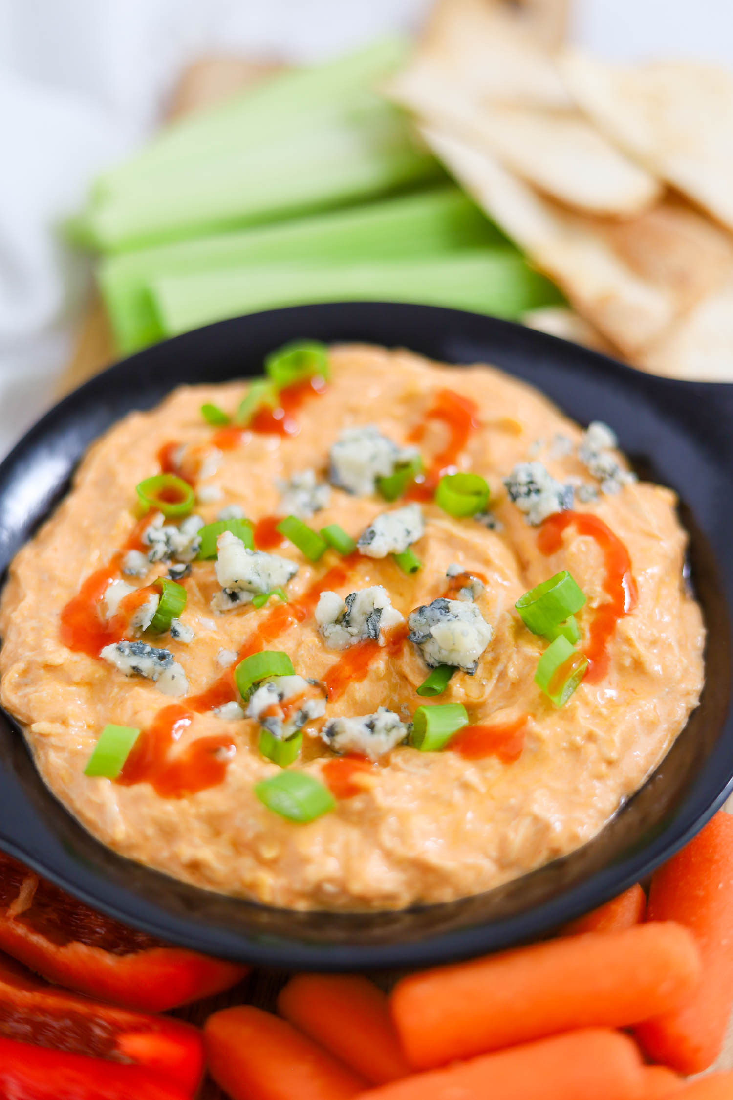 instant pot buffalo chicken dip with raw veggies and tortilla chips 