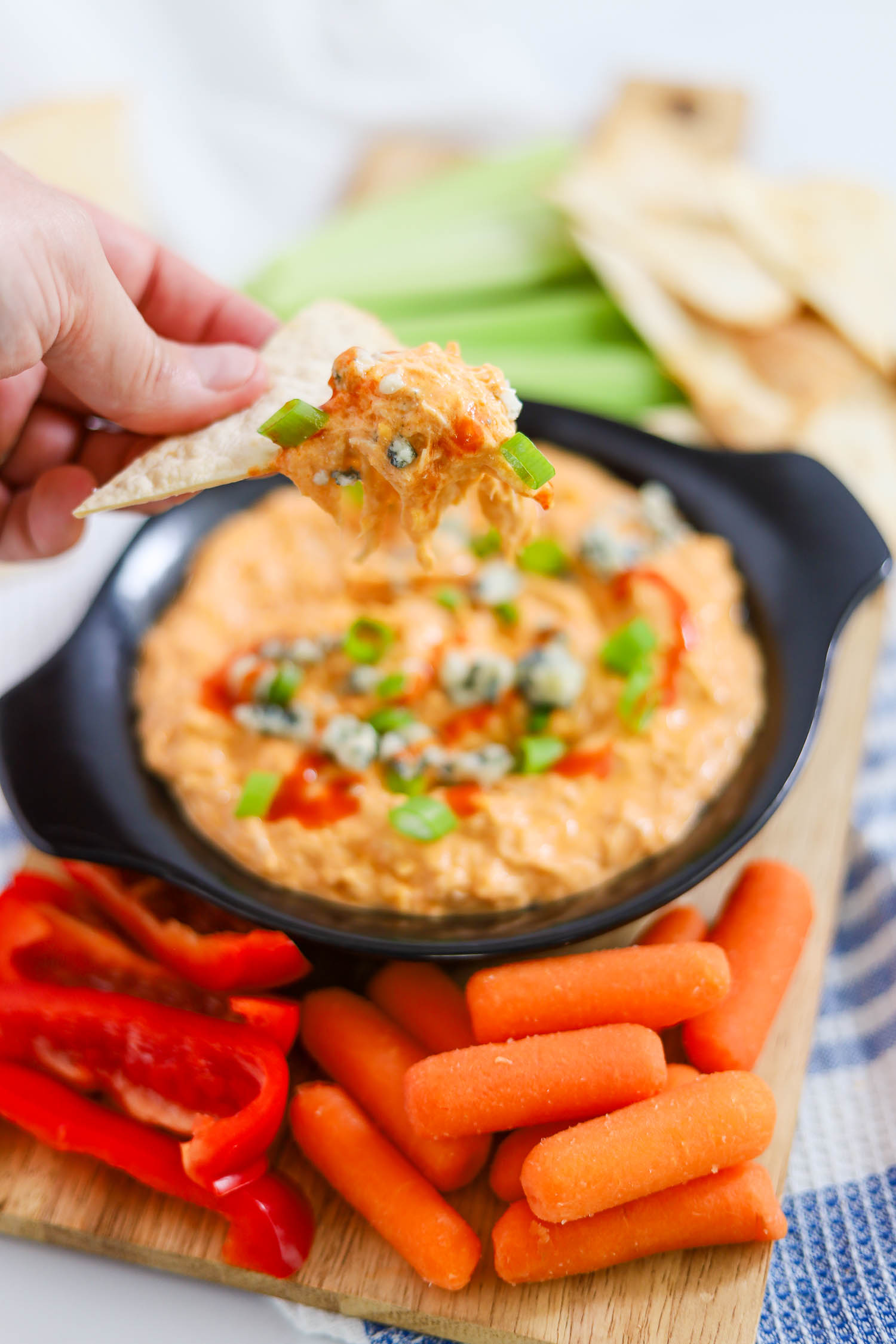 dipping a chip into keto buffalo dip 