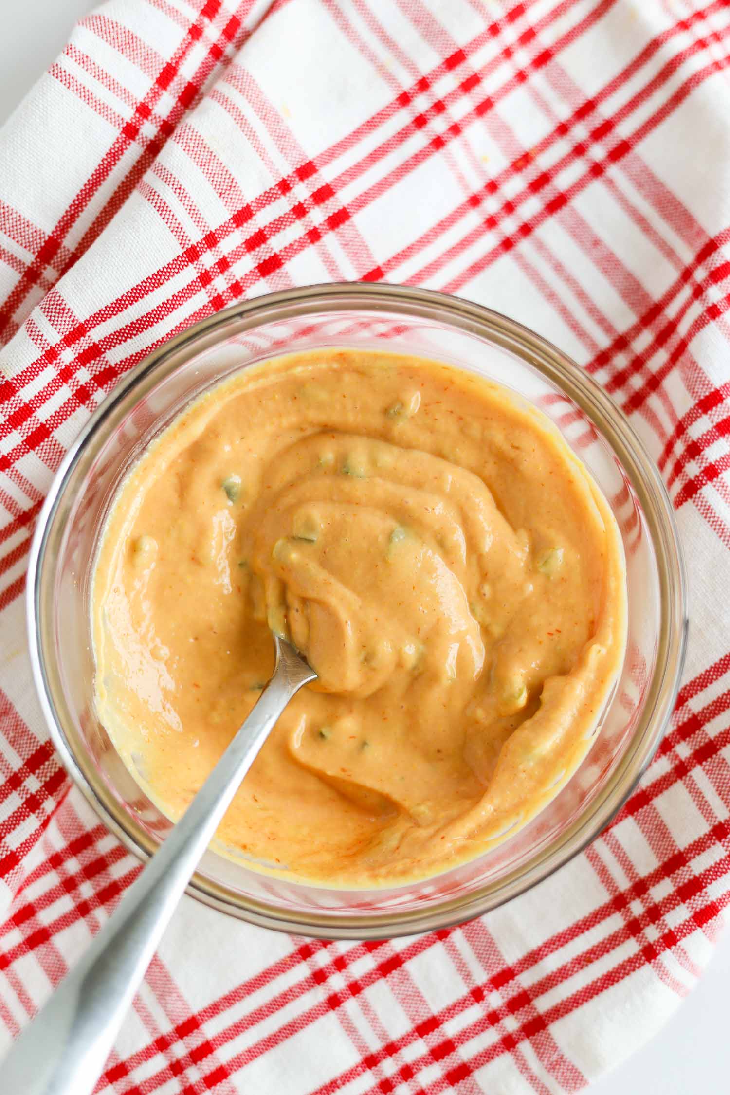 mixing together big mac sauce in a glass bowl 