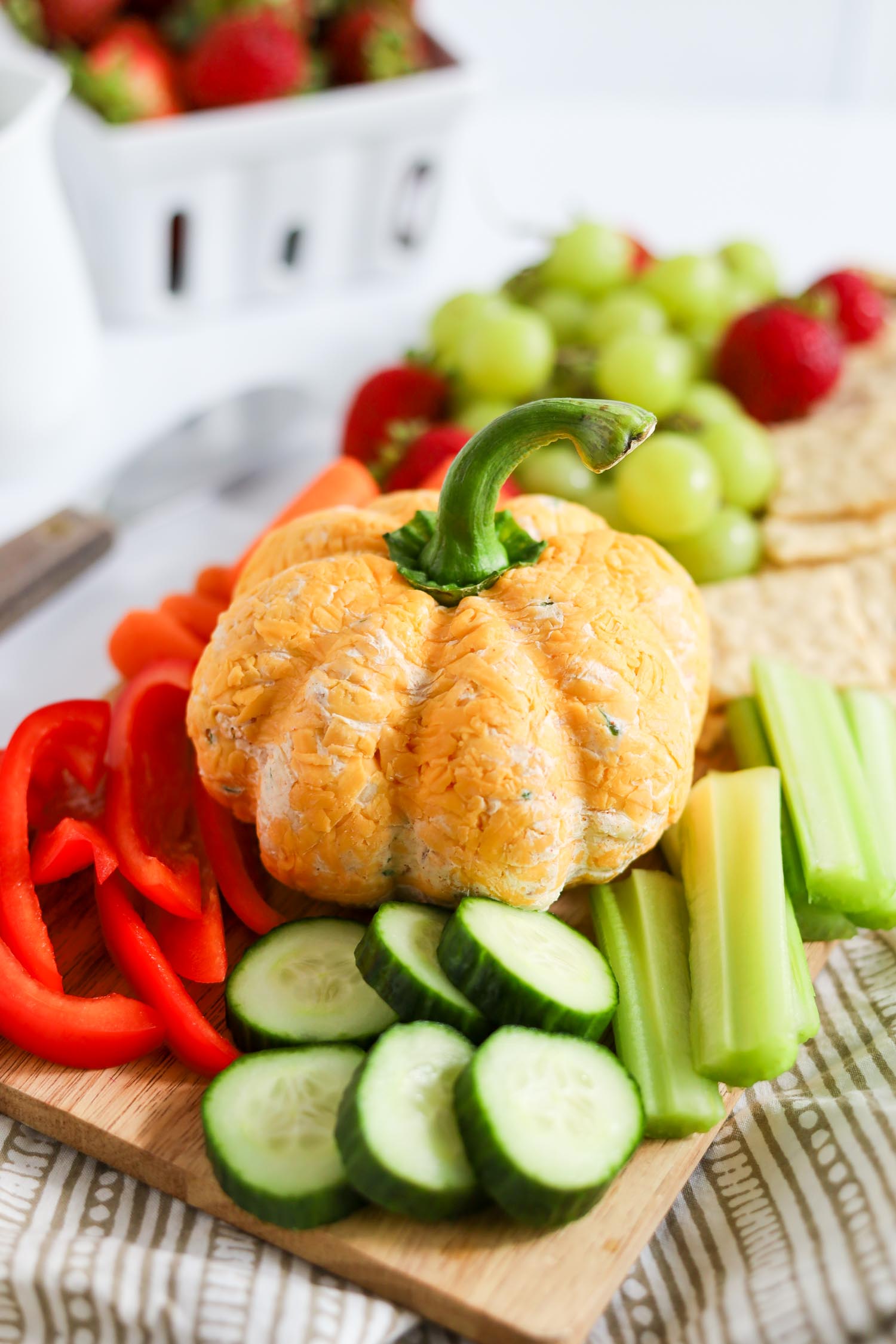 pumpkin shaped cheese ball topped with bell pepper stem 