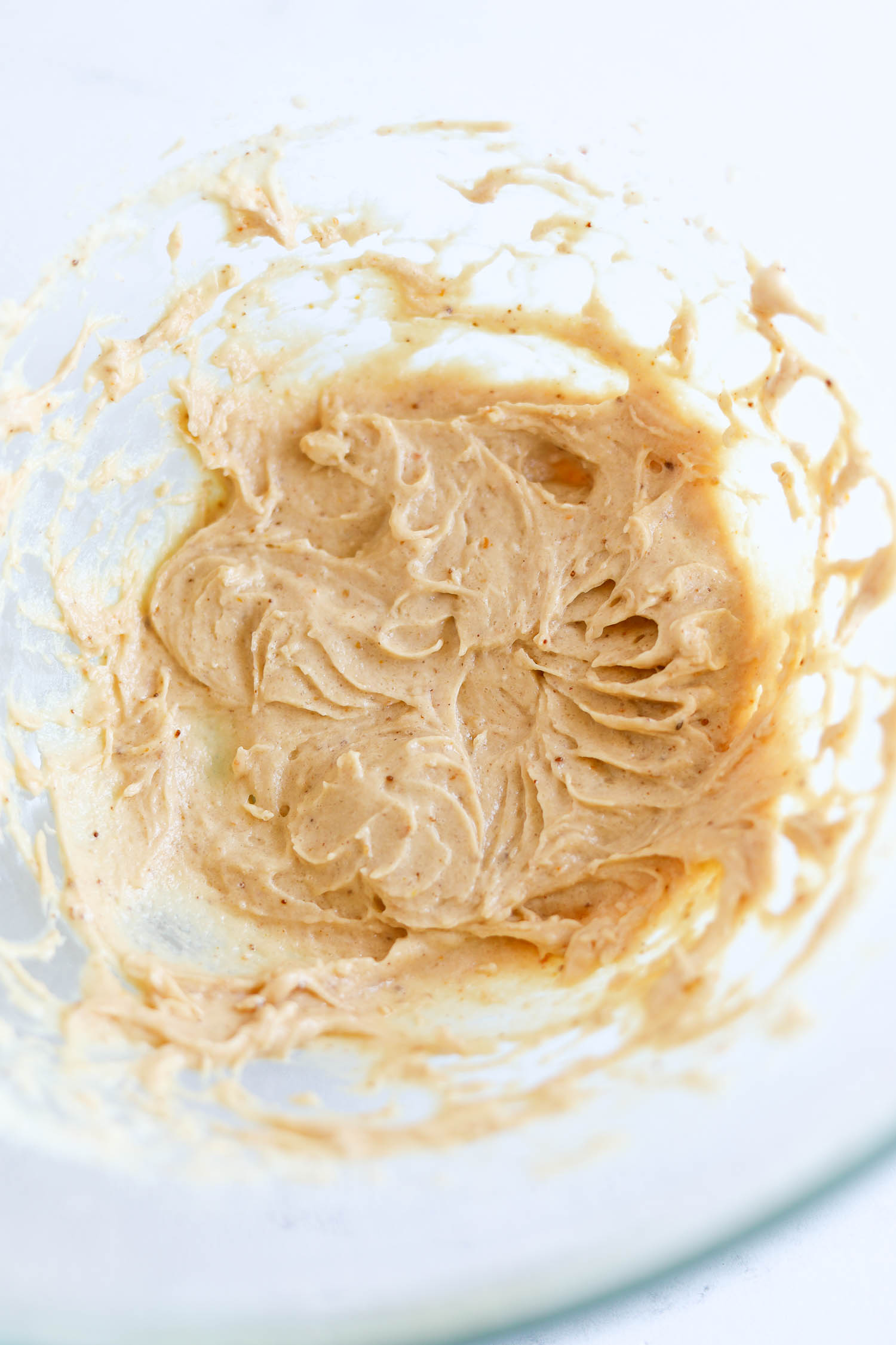 whipping peanut butter in a bowl 