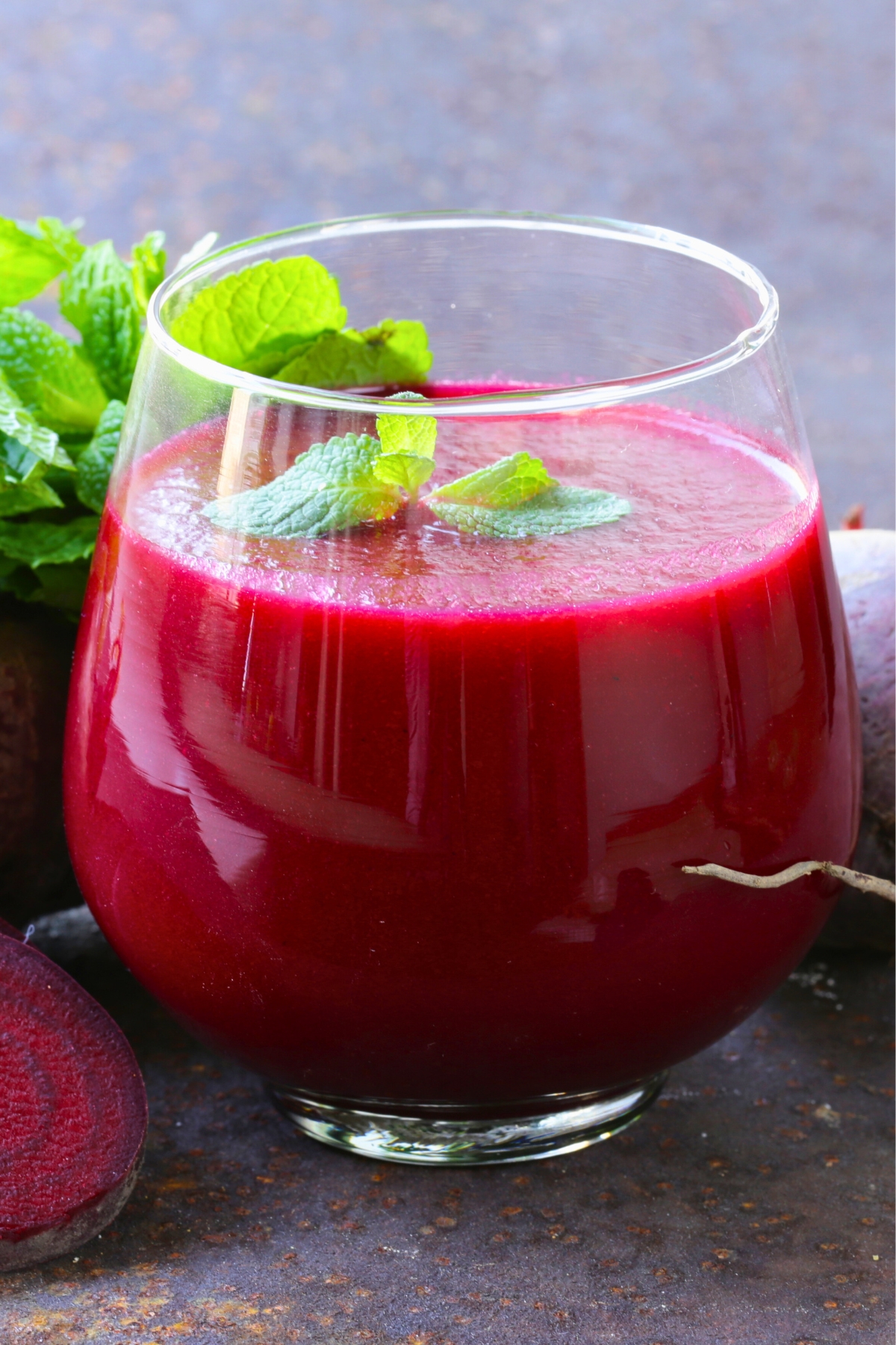 beet juice in a glass topped with parsley 