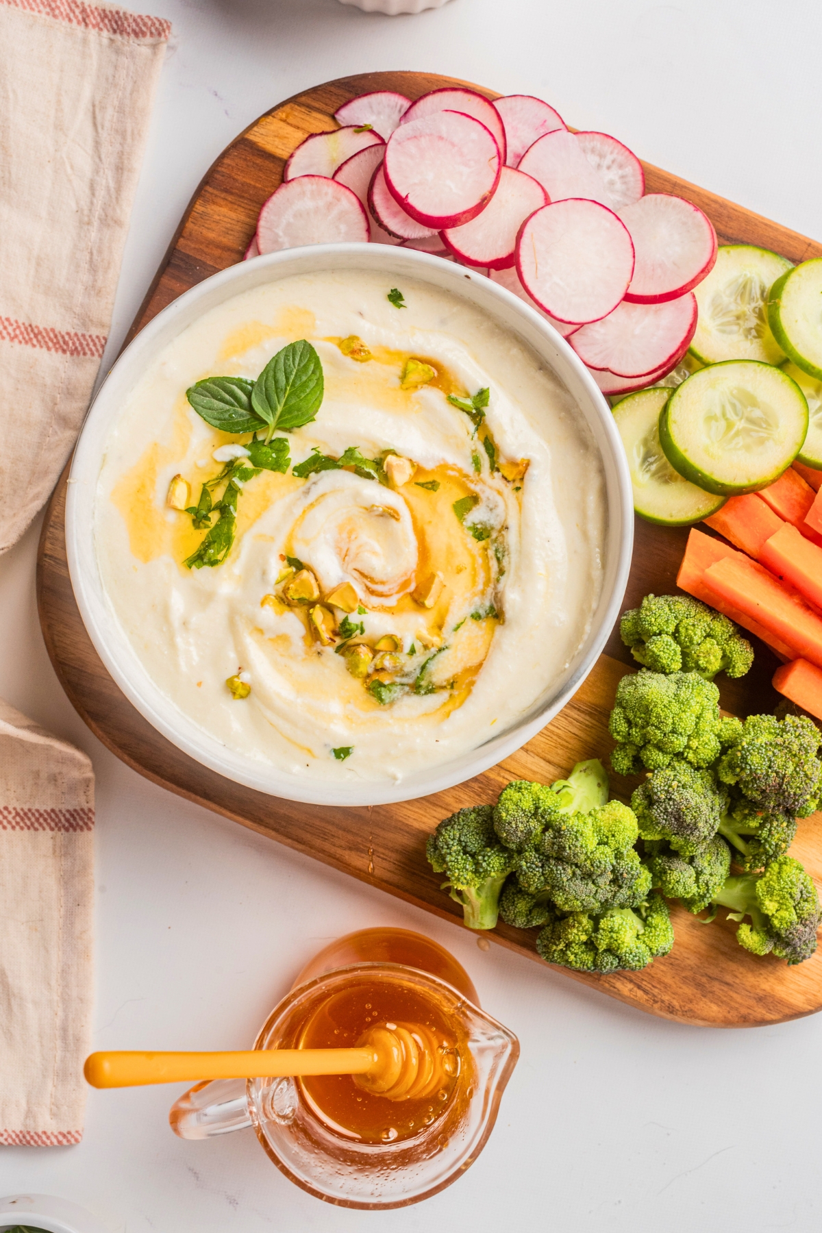 whipped feta dip in a bowl with chopped veggies 