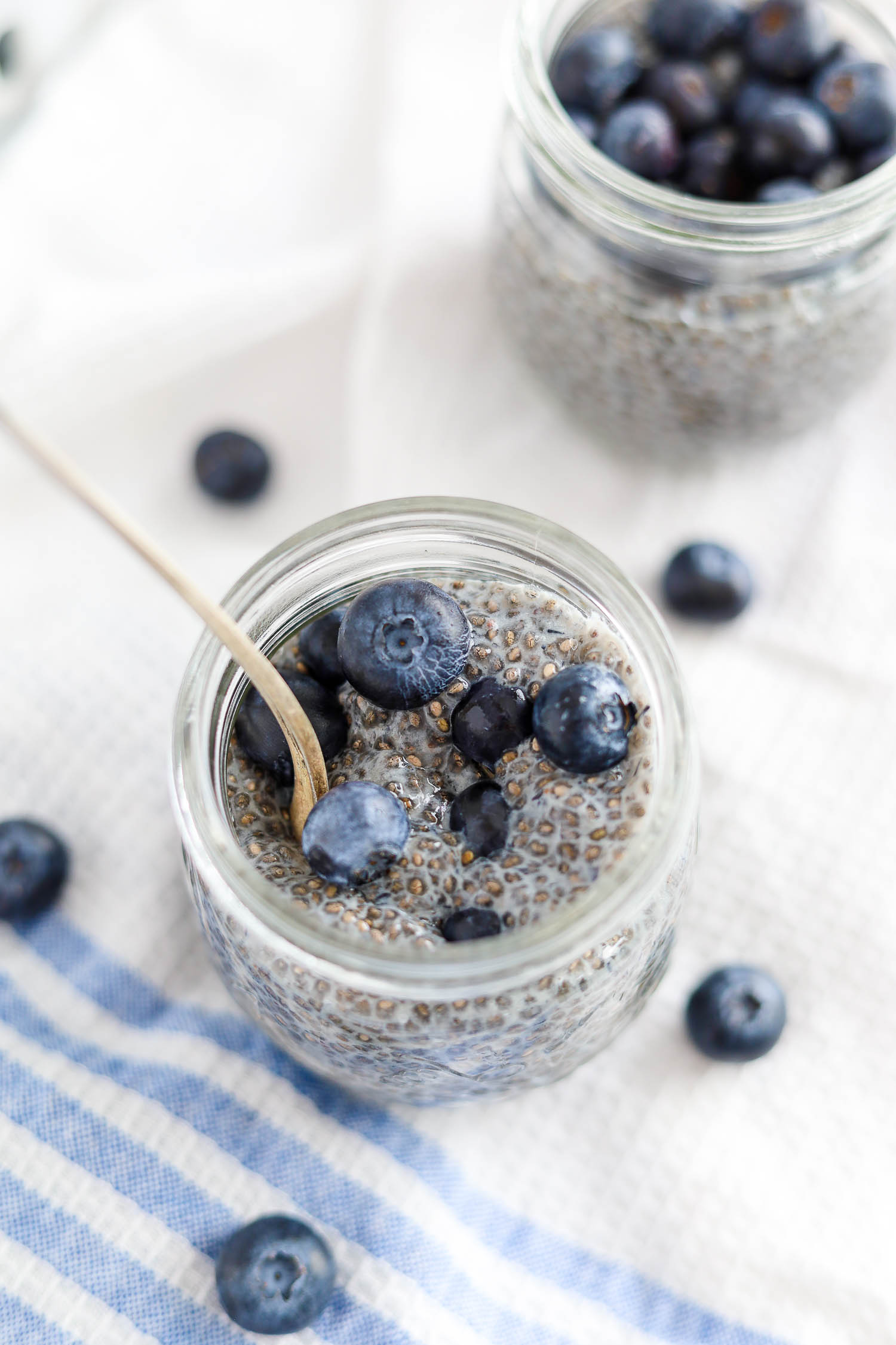 mixing berries into cold chia pudding