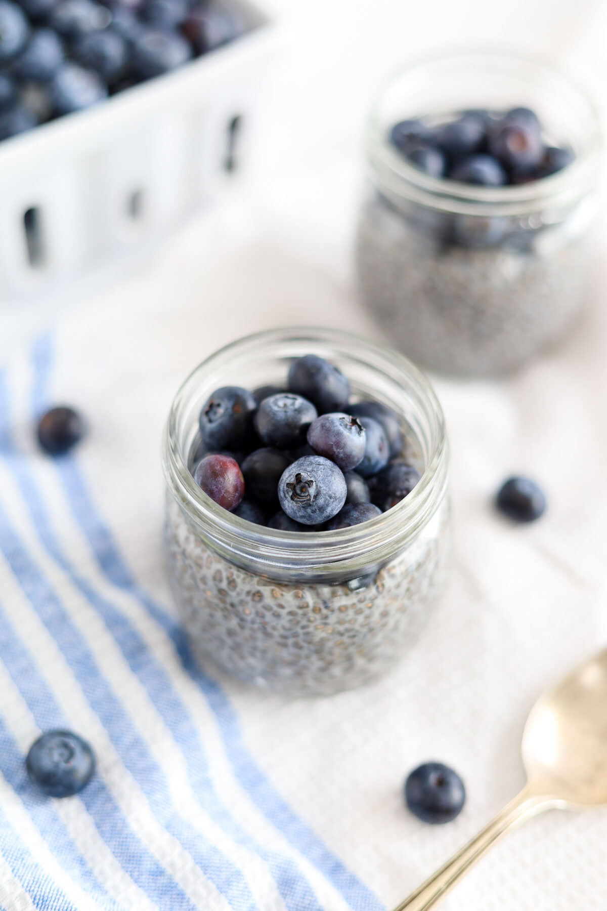 adding fresh blueberries on top of chia seed pudding 