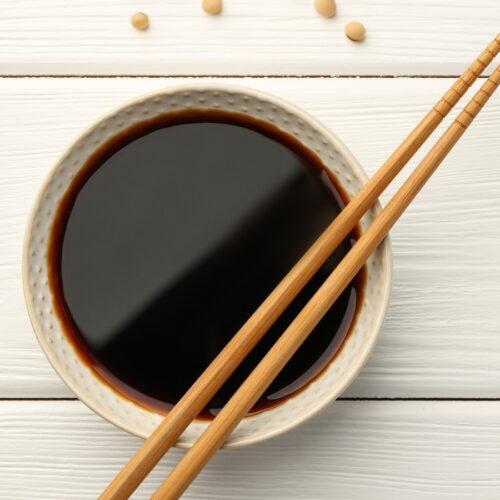 soy sauce in a bowl with chopsticks