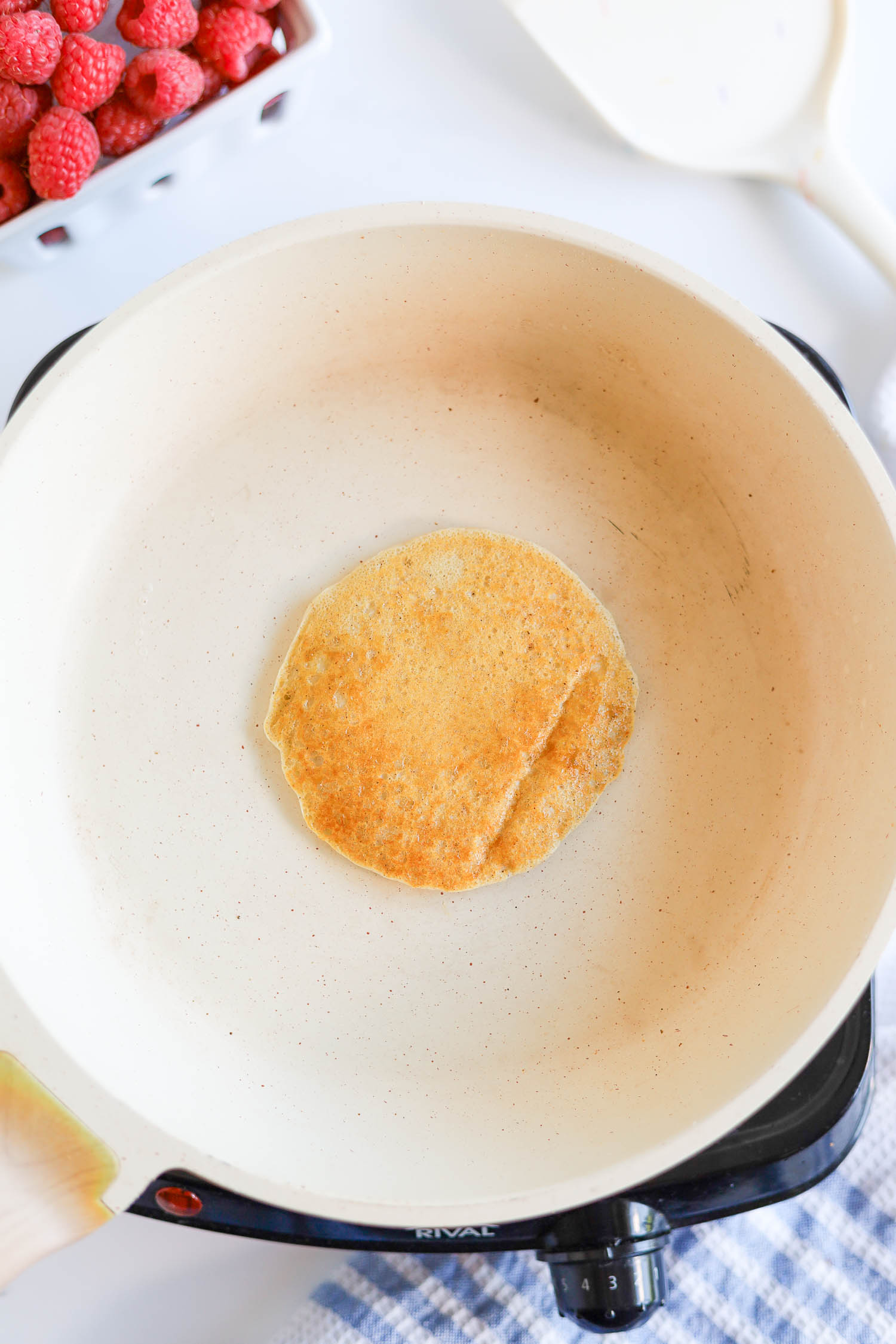 cooking small pancakes on a hot griddle