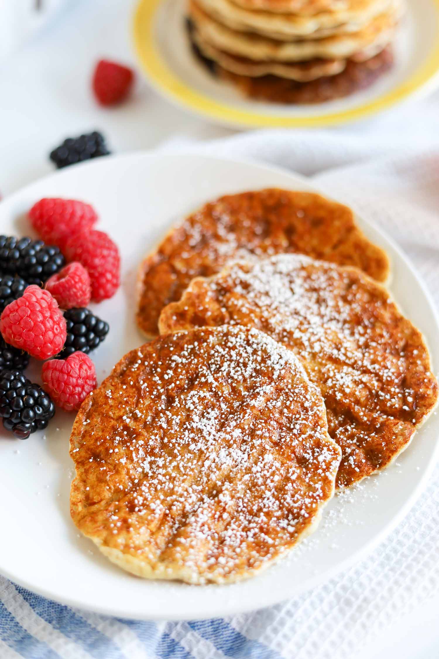 healthy cottage cheese pancakes on a plate with berries