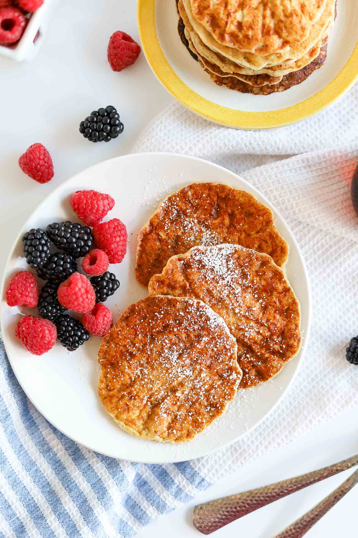 overhead shot of cottage cheese pancakes with raspberries and blackberries.