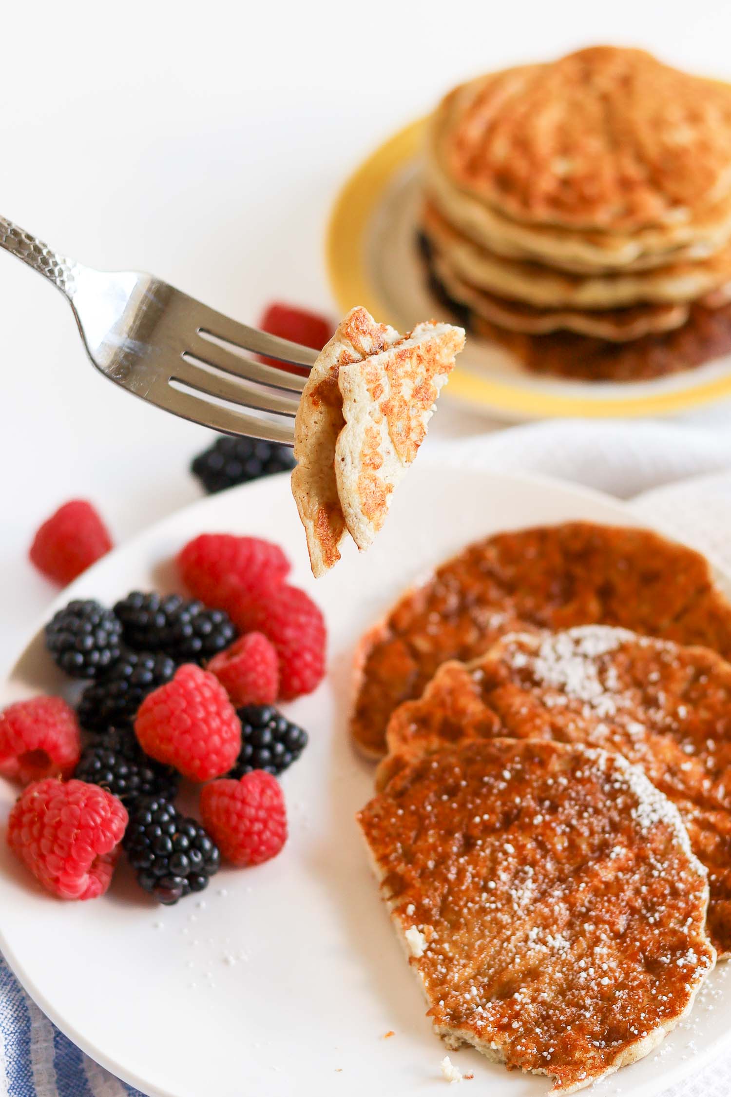 eating a bite of high protein cottage cheese pancakes with keto maple syrup
