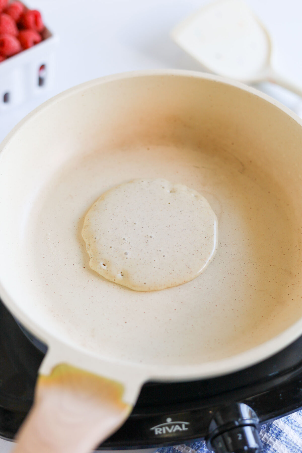 adding keto pancake batter to a hot pan