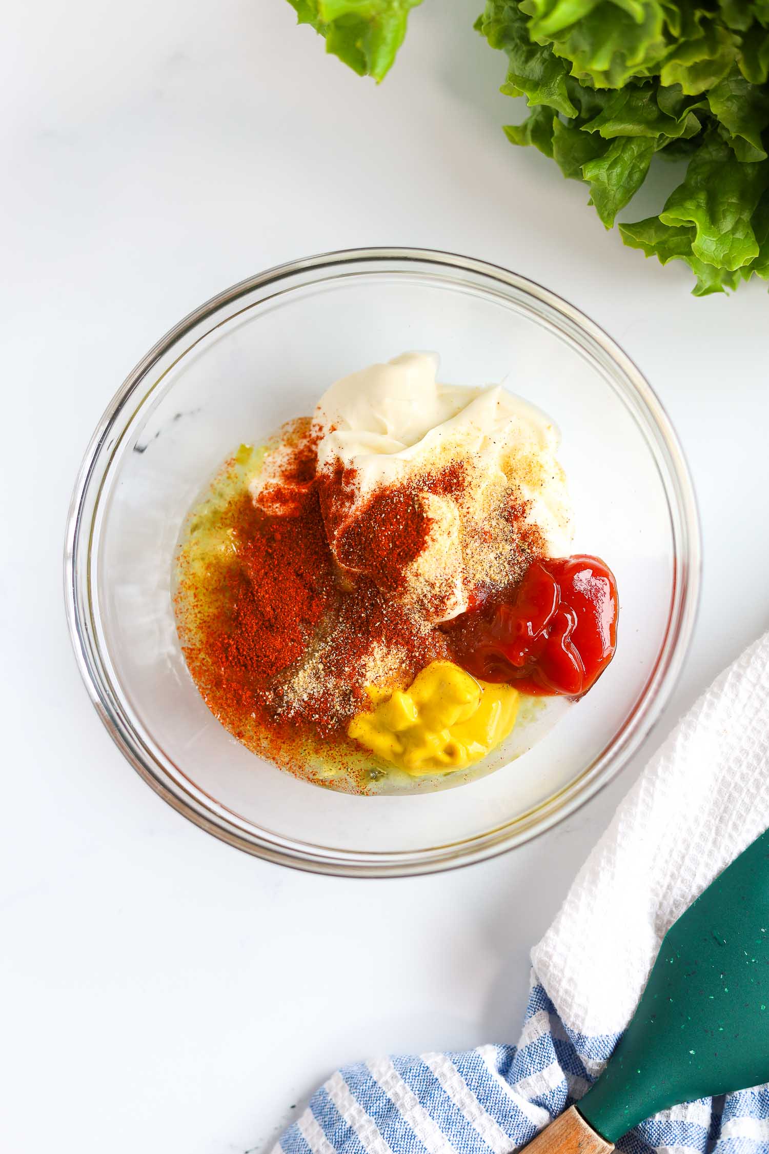 adding ketchup, mayo and pickle relish to a glass bowl