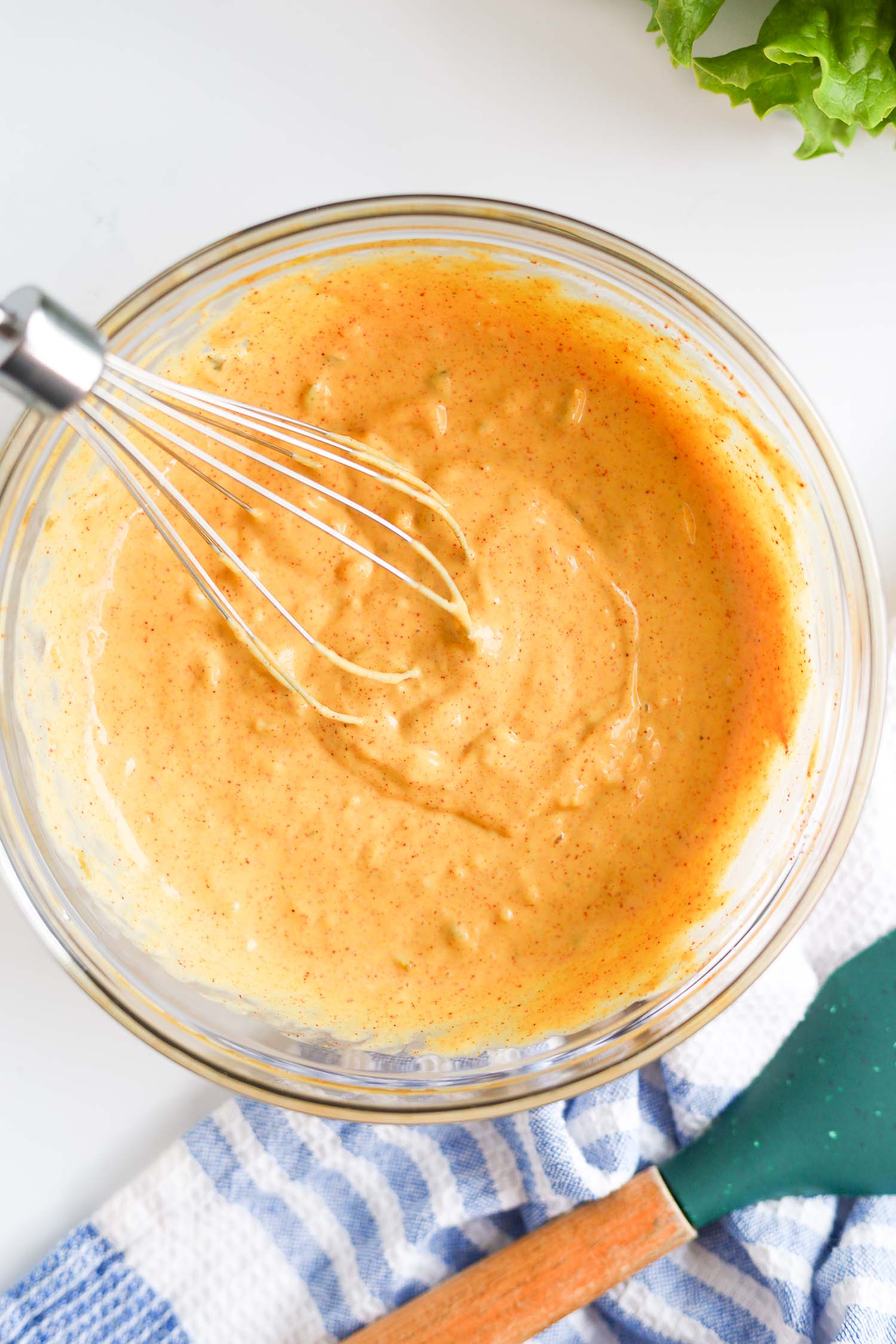 mixing sauce ingredients with a whisk