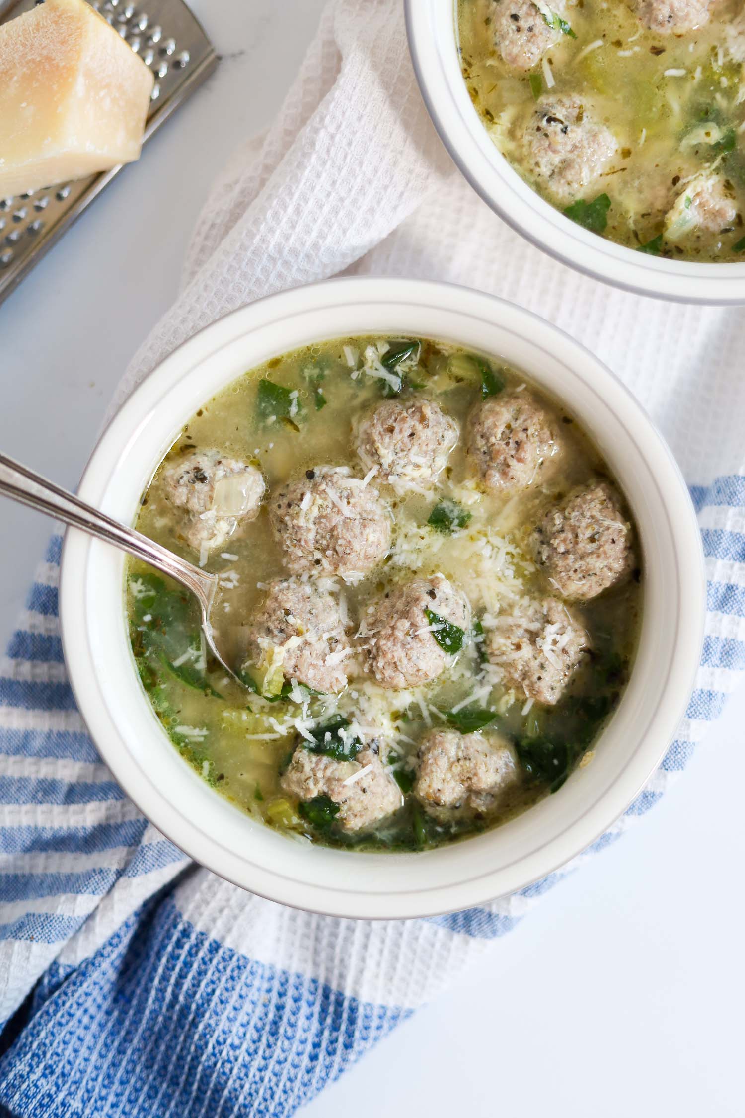 a white bowl filled with gluten free italian wedding soup