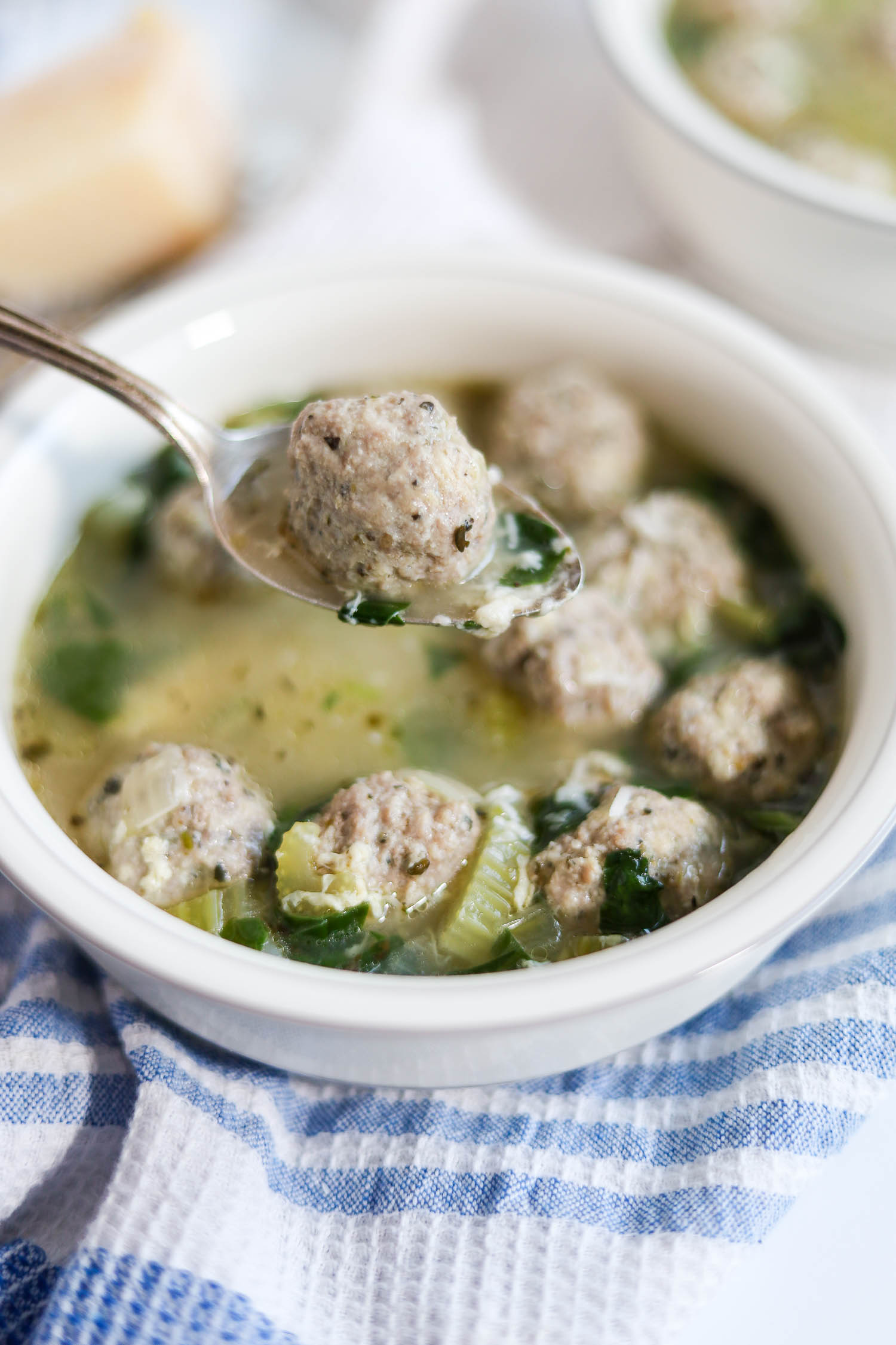 eating meatballs from italian soup with a soup 