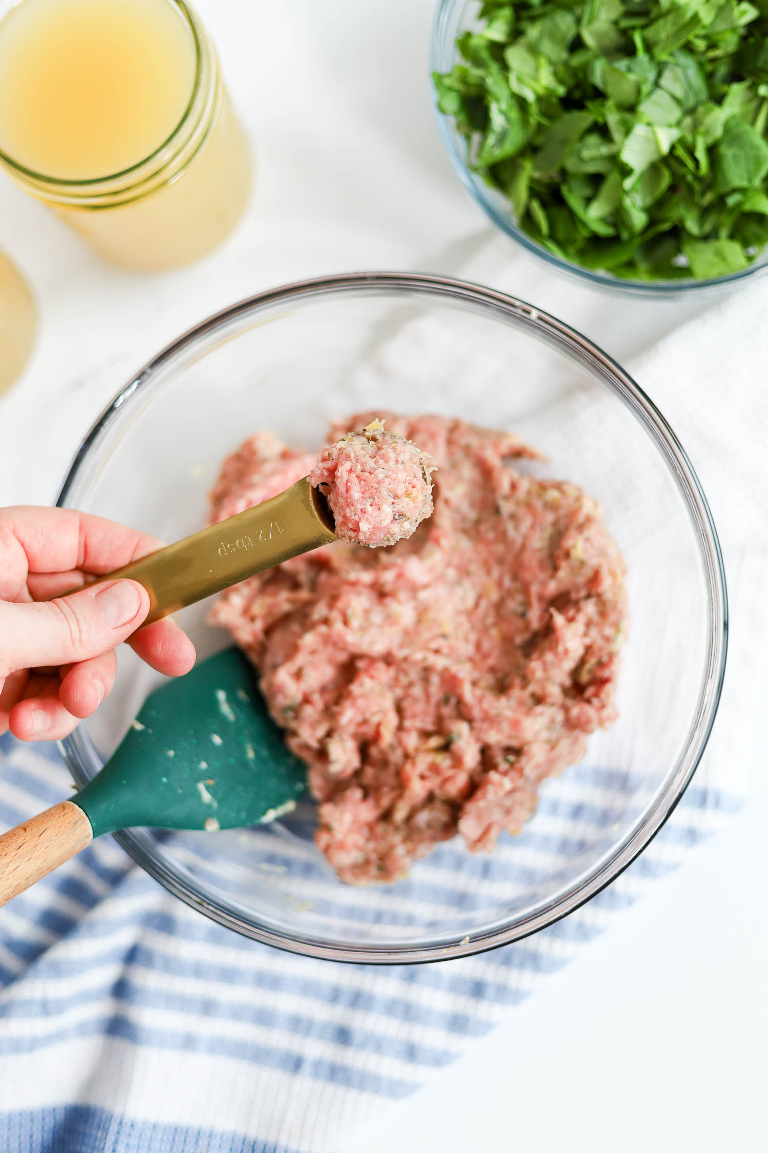 using a teaspoon to measure out mini meatballs