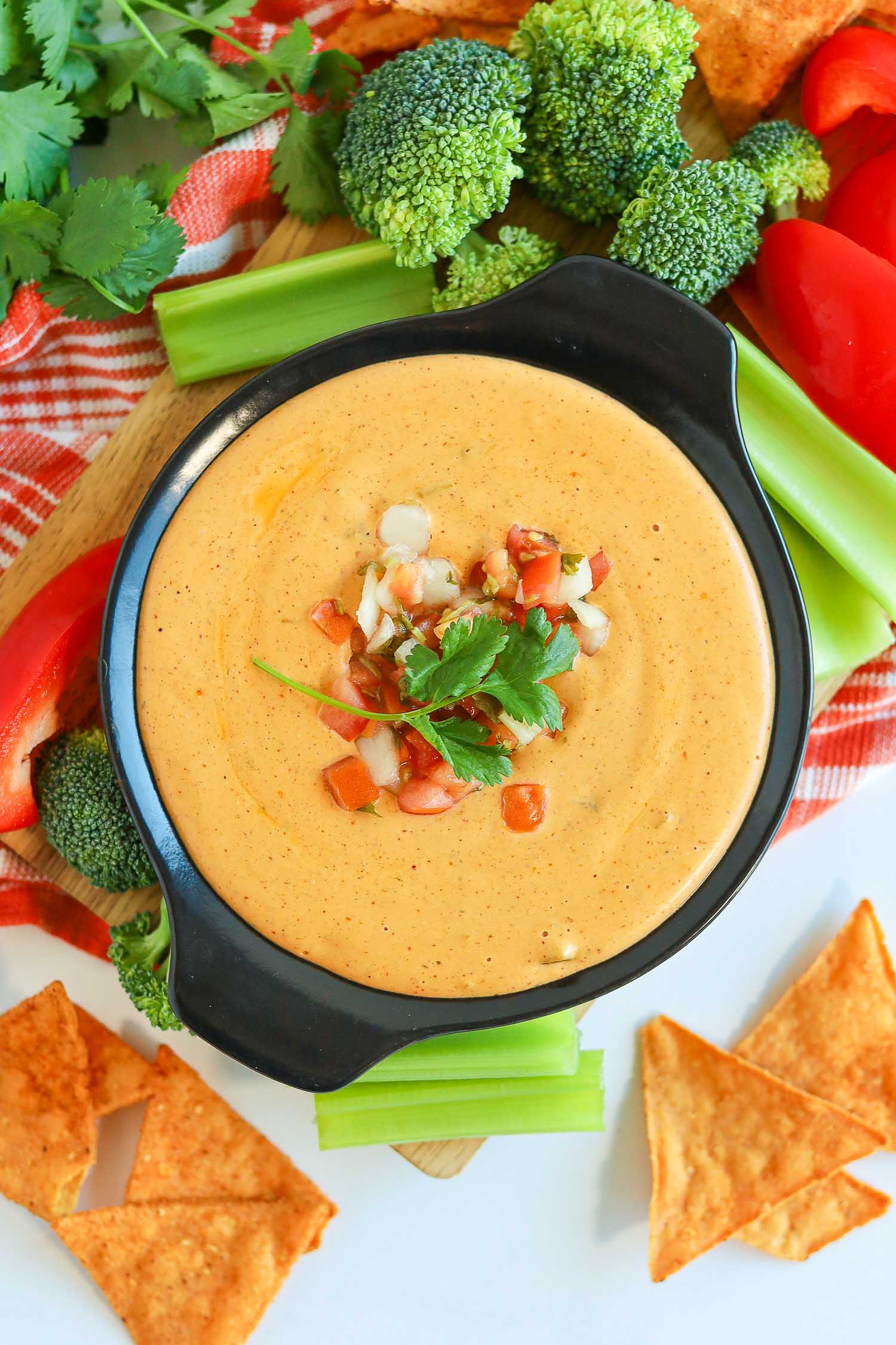 cottage cheese queso in a black bowl with veggies