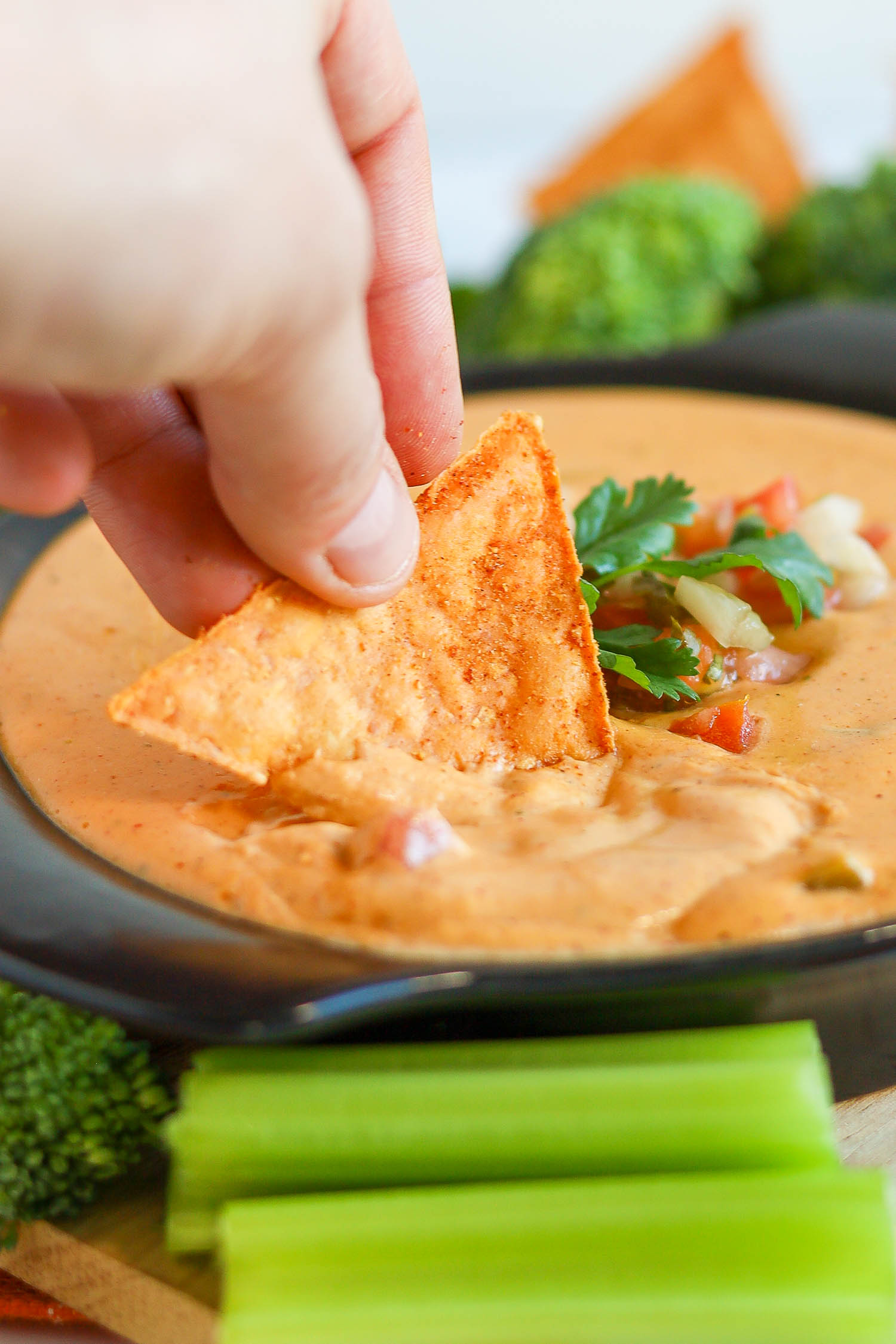 dipping a tortilla chip into keto cottage cheese queso 