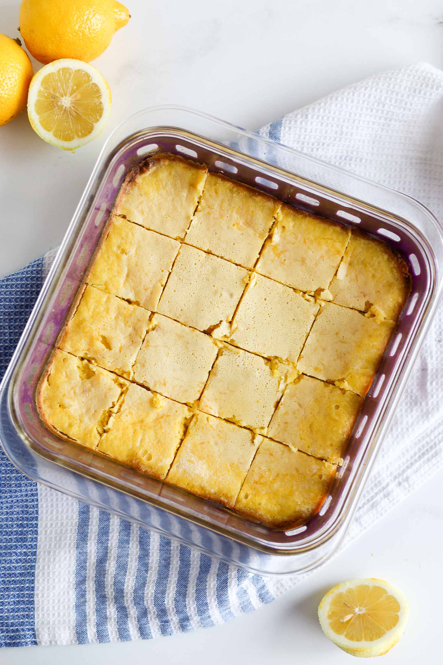 sliced lemon squares in a glass casserole dish